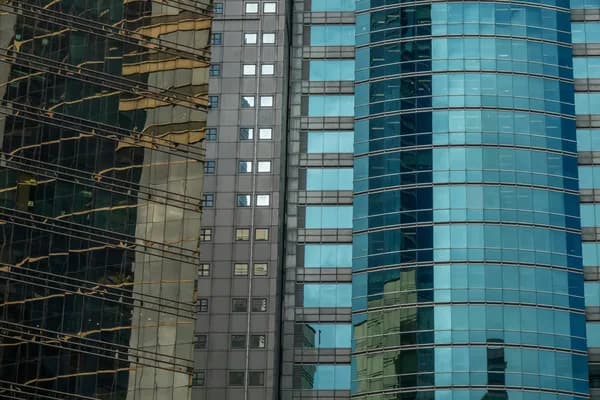 Modern skyscraper glass facades showing reflective windows and building exteriors
