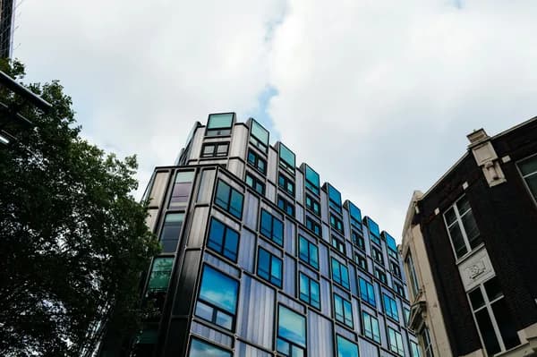 Modern commercial building exterior with reflective glass windows and metal framing