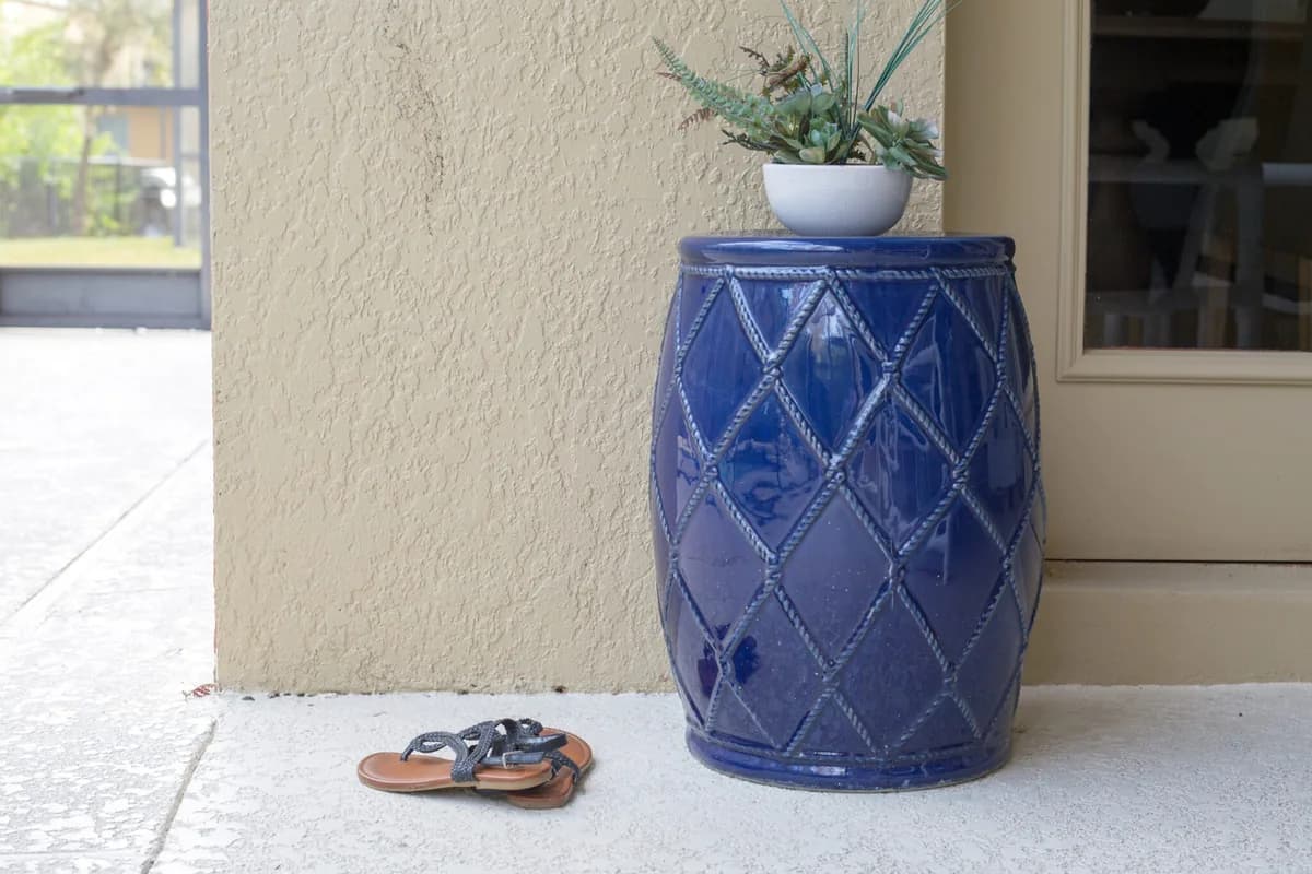 Blue ceramic planter with succulents on residential patio near window