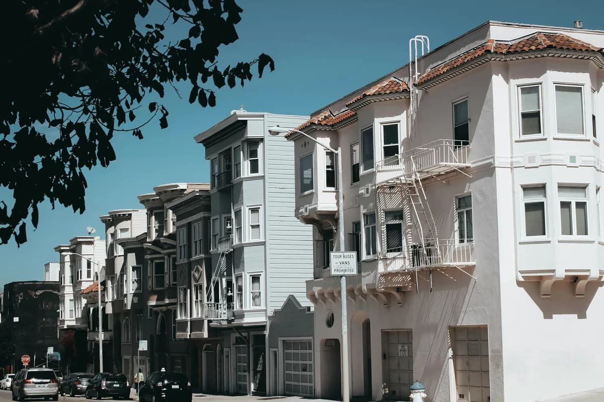 Row of historic residential buildings with multiple windows and architectural details