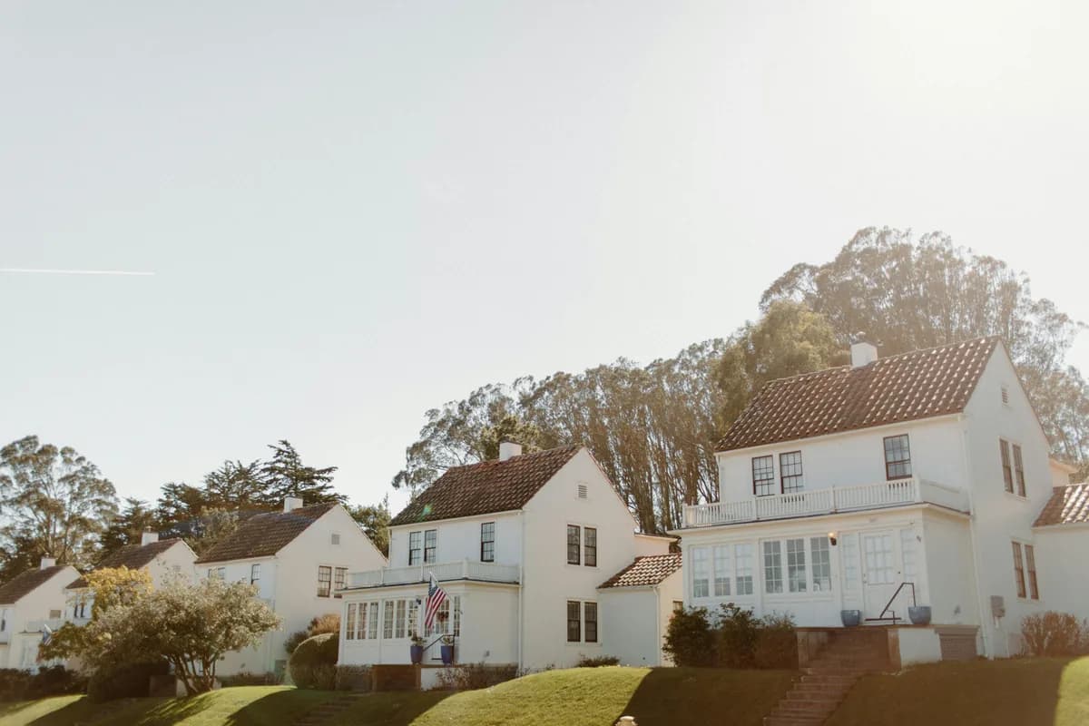 White residential houses with clean windows and manicured lawns