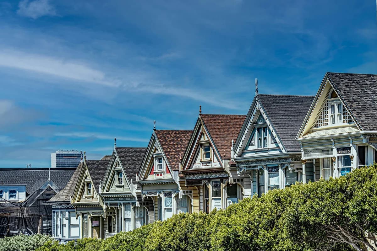 Row of Victorian houses with large windows and steep pitched roofs
