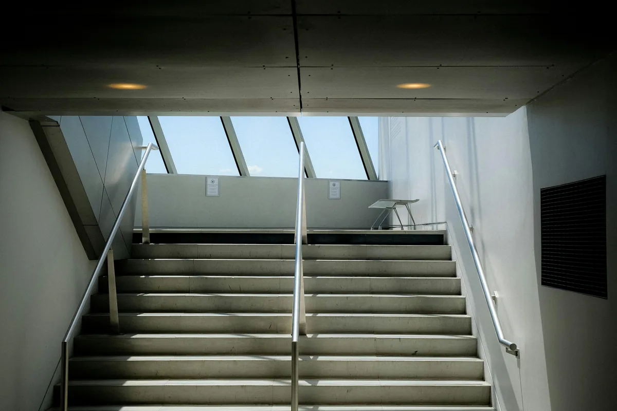 Modern stairwell with skylights and metal railings in contemporary building