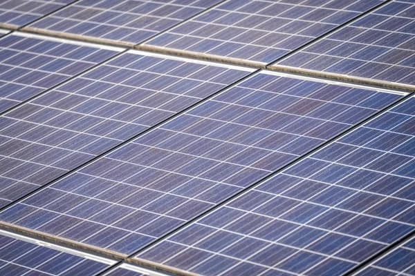 Close-up view of solar panels arranged in rows on rooftop surface