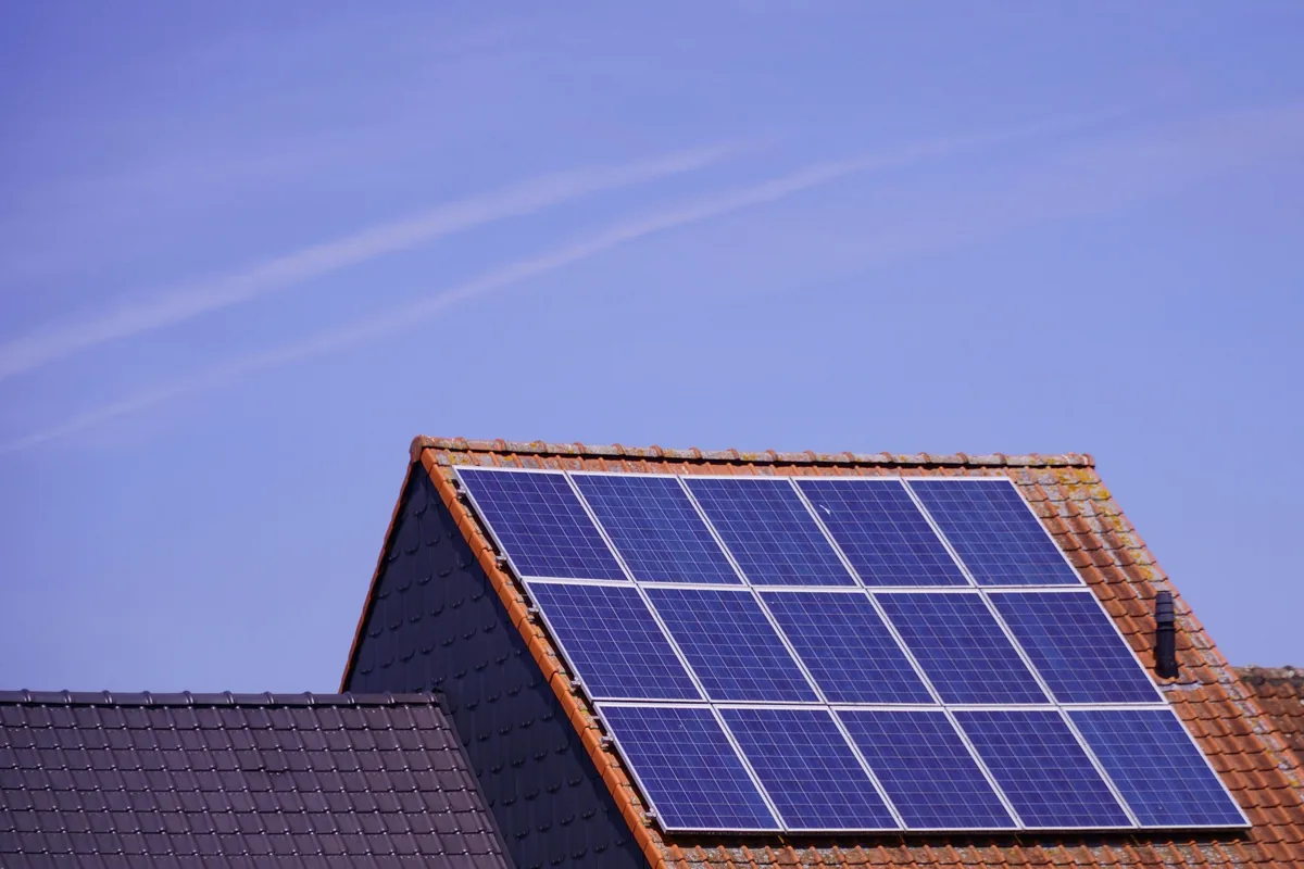 Solar panels installed on residential roof with terracotta tiles