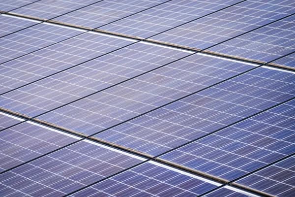 Close-up view of installed solar panels with grid pattern and metal frames