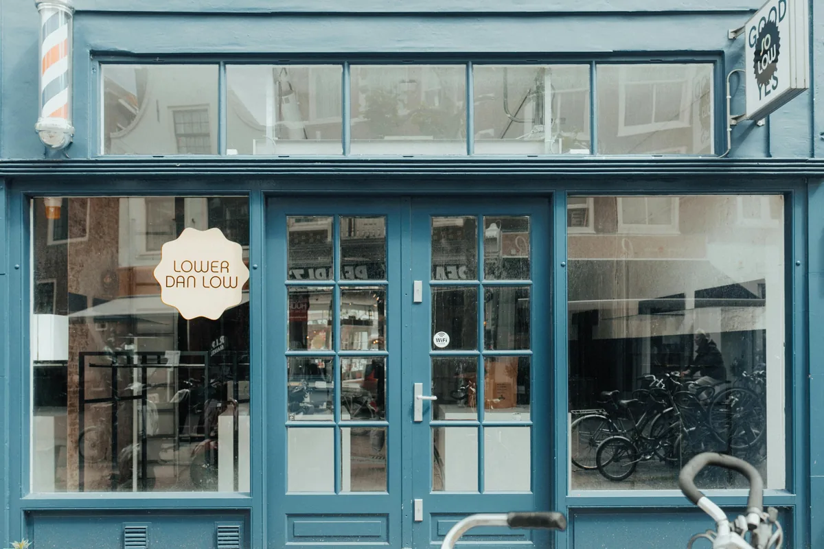 Blue storefront facade with gridded windows and glass door entry