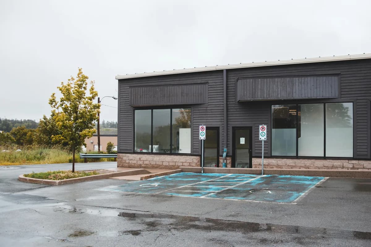 Modern commercial building with large windows and dark exterior cladding