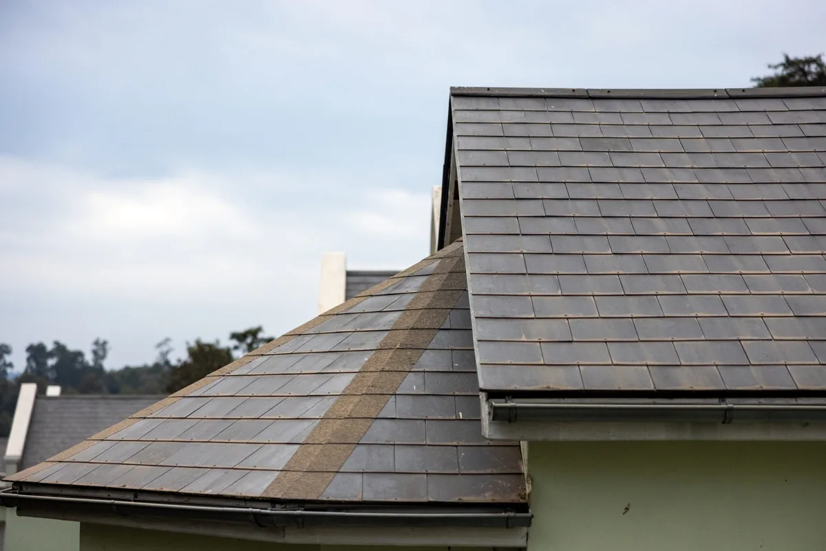 Slate tile roof with dormer on residential house exterior