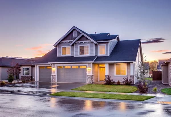 Modern two-story residential home with clean windows at dusk
