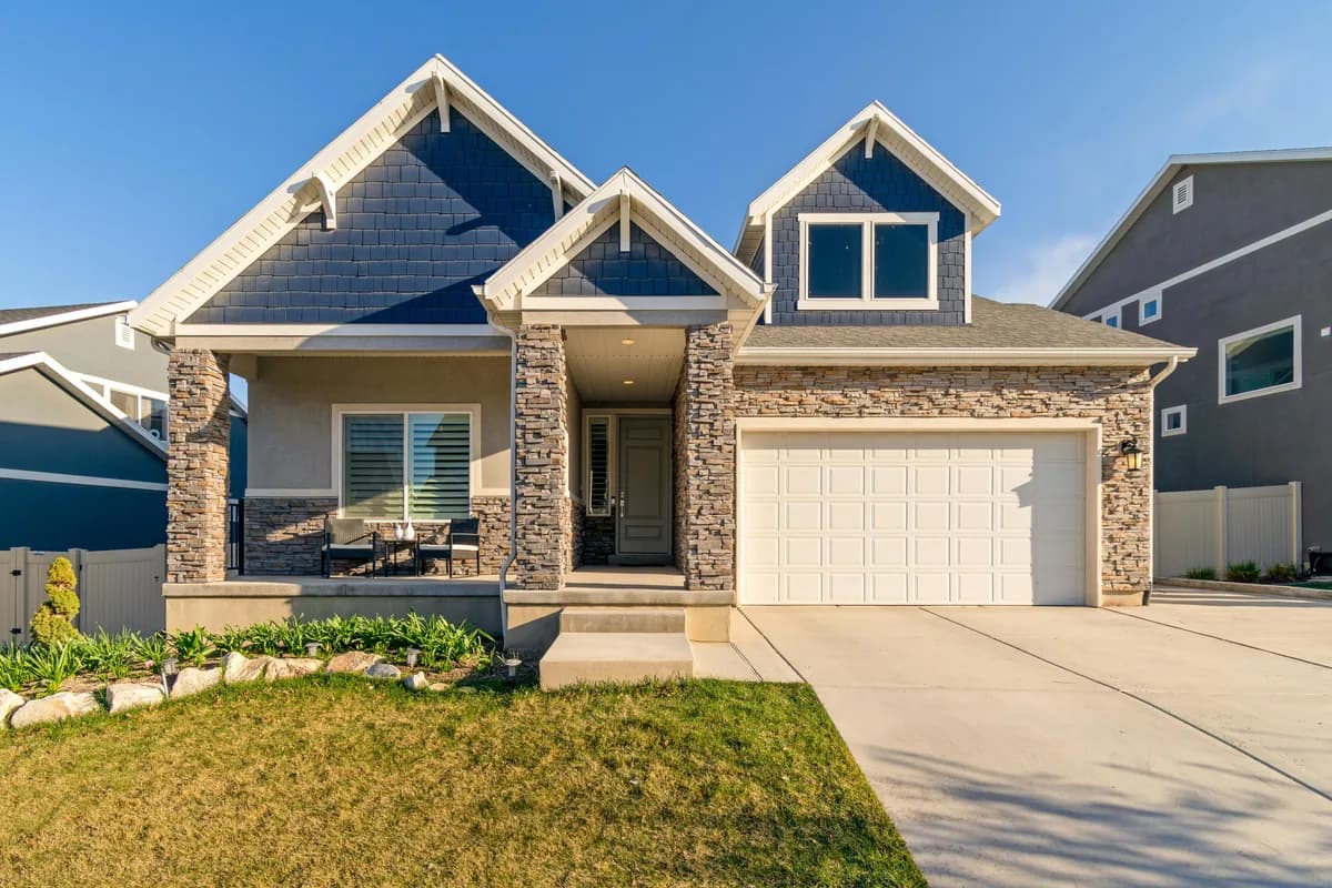 Modern two-story residential home with stone accents and large windows