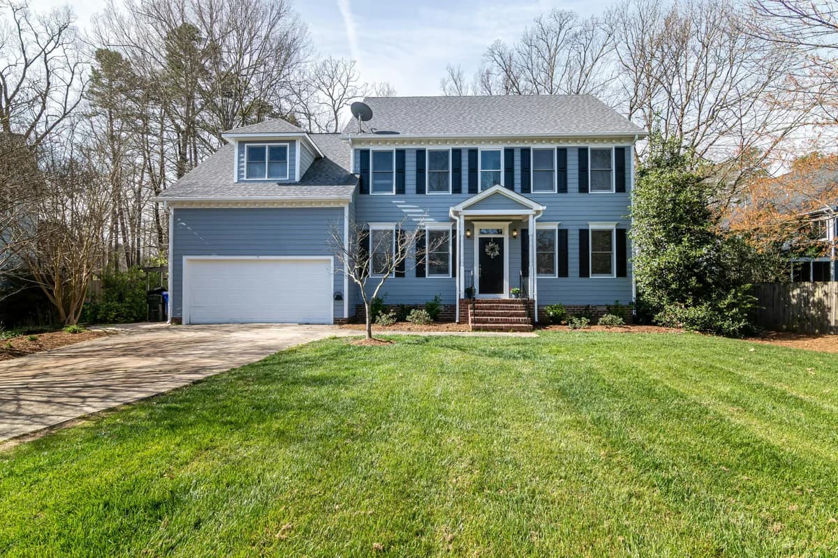 Two-story residential house with clean windows and manicured lawn