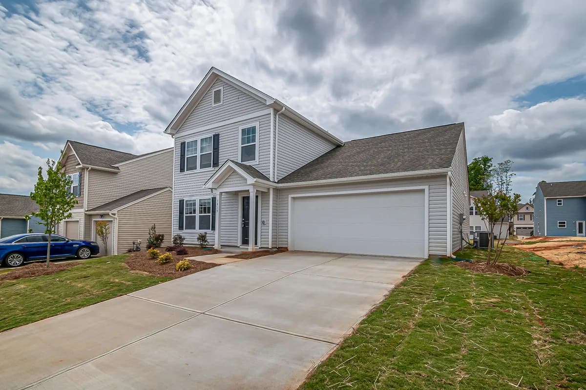 Two-story residential house with white siding and attached garage