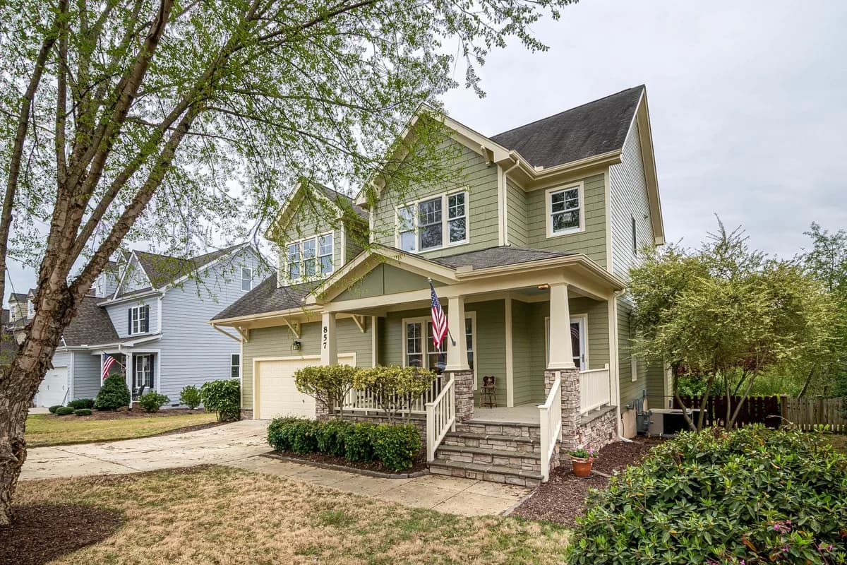 Two-story residential home with clean windows and front porch entrance